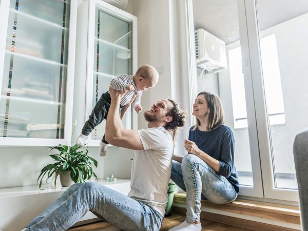 Frau und Mann spielen mit einem Kind.